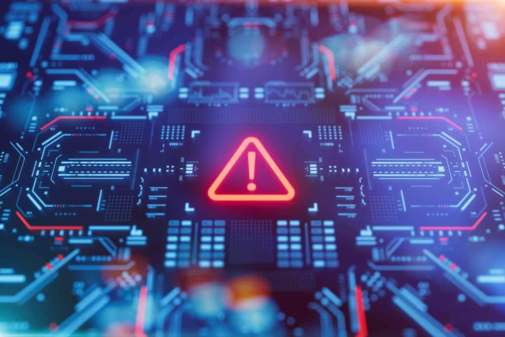 Icône d’alerte rouge sur une carte électronique symbolisant une cyberattaque et une faille de sécurité informatique
