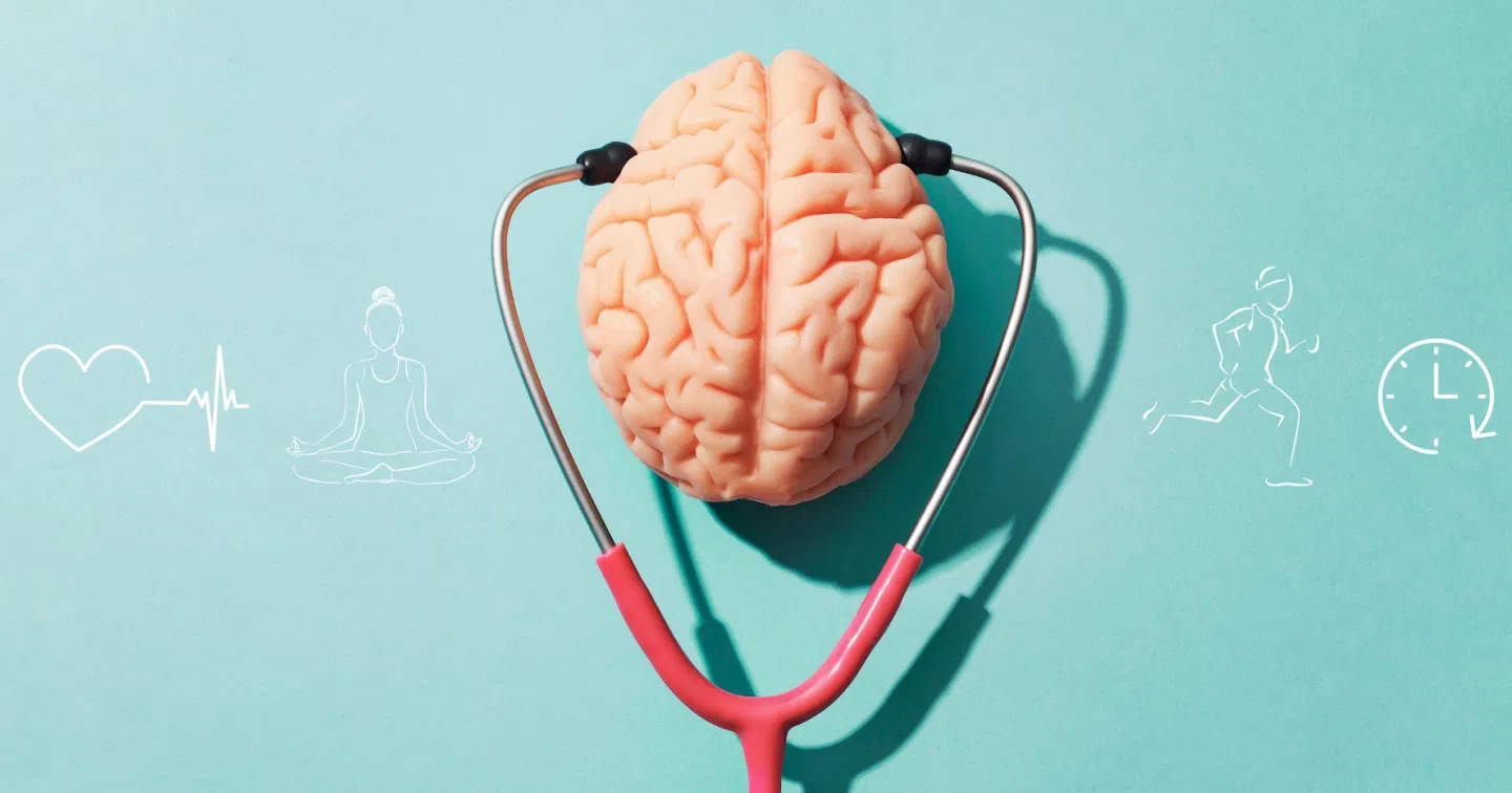 Un cerveau placé entre les embouts d’un stéthoscope sur un fond bleu, symbolisant la santé mentale, entouré d’icônes de bien-être, de méditation, de sport et de gestion du temps.