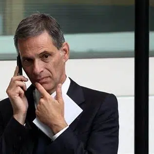 Rodolphe Saadé au téléphone, en costume sombre, lors d’un déplacement.