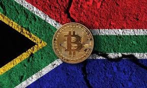 Pièce de Bitcoin posée sur un drapeau sud-africain illustrant les nouvelles tensions autour de la régulation des cryptomonnaies en Afrique du Sud.